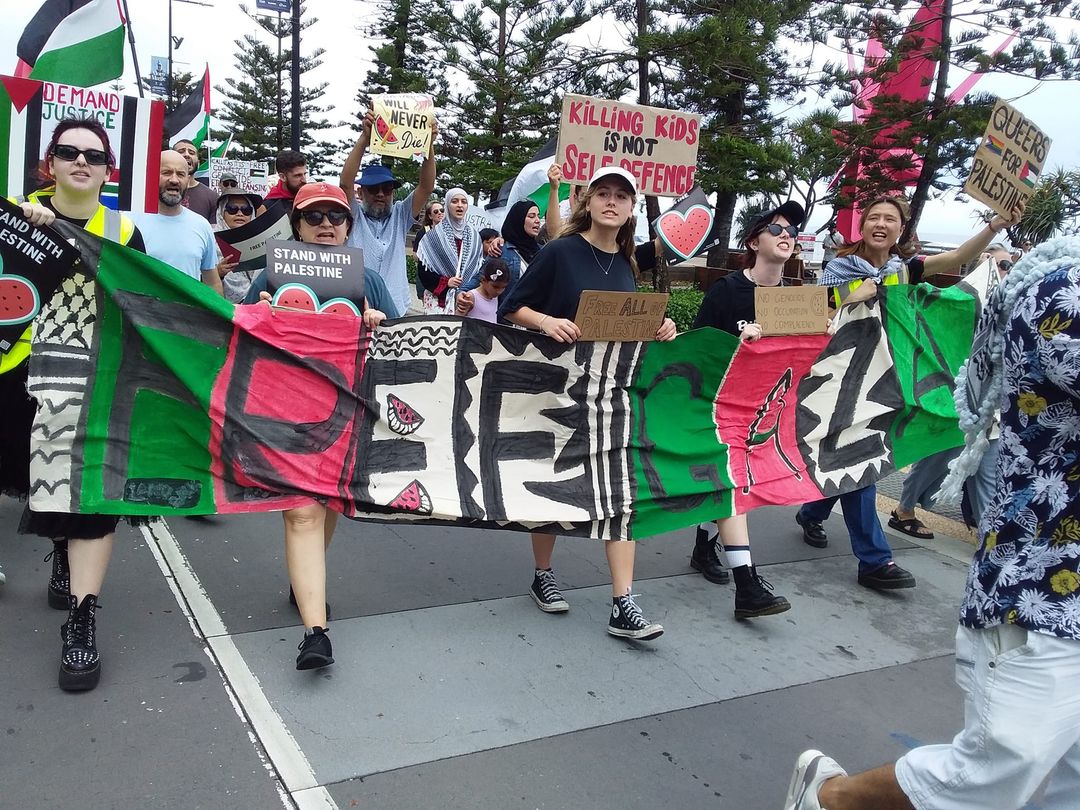 women holding a banner and marching