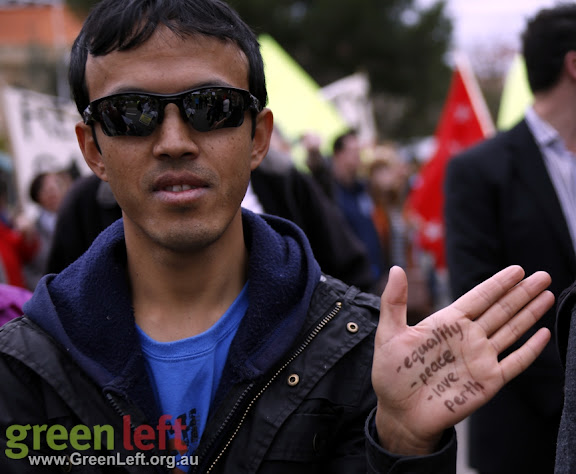 Protester with hand written sign on palm