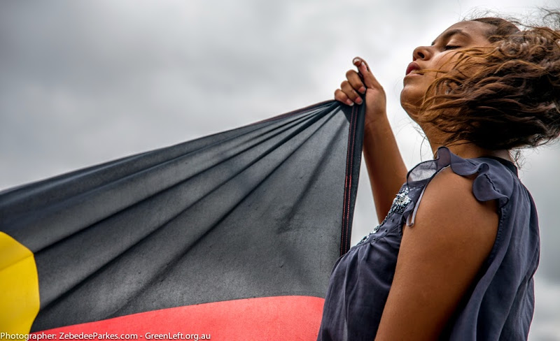 Marching with the Aboriginal flag.