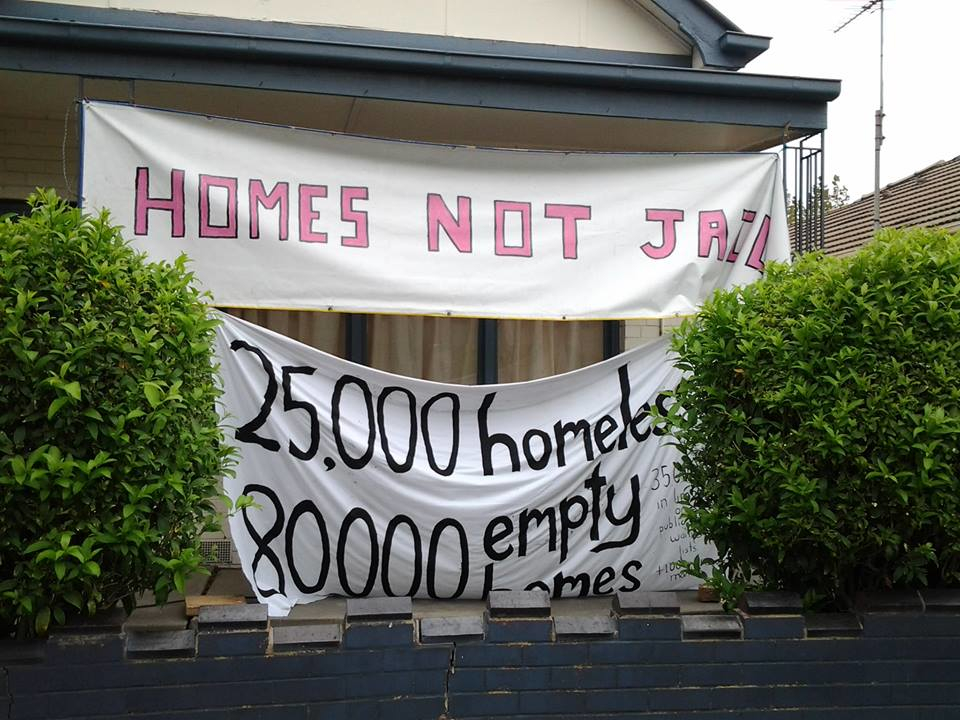 Homes not jail banner at Homeless People's Unit vacant propert occupation Collingwood Melbourne 2016.