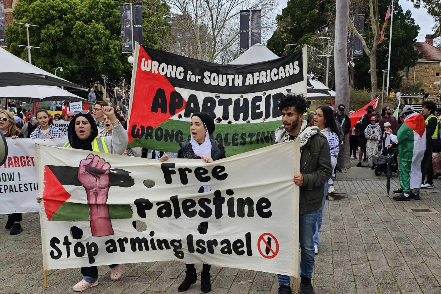 protesters hold banners