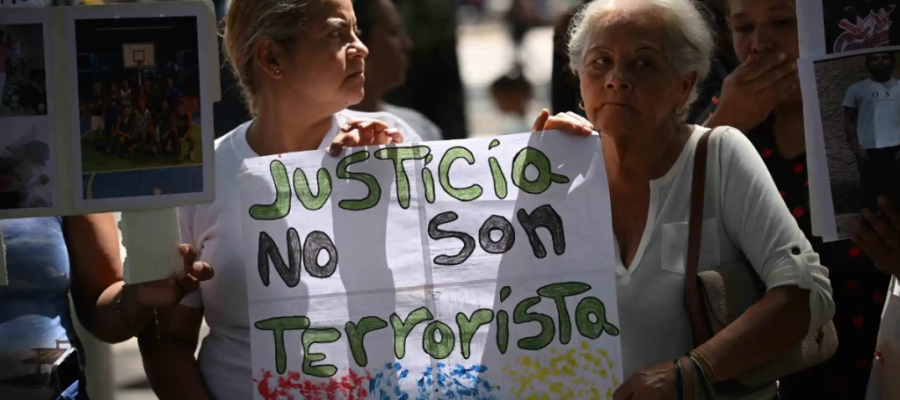 Two women holding a protest sign