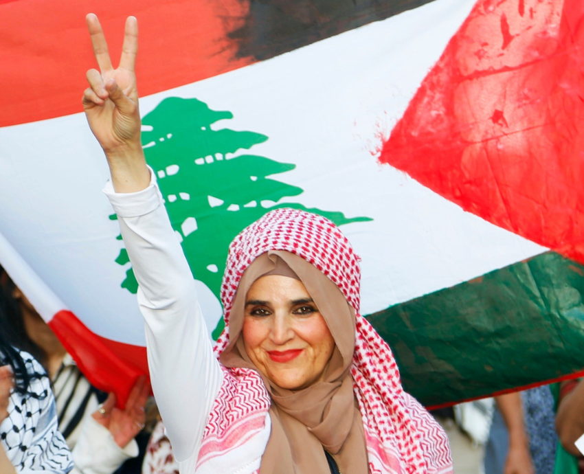 Protester in front of Lebanese flag