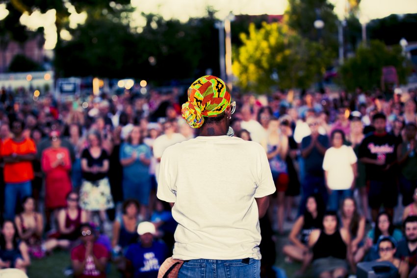 a woman in front of a crowd