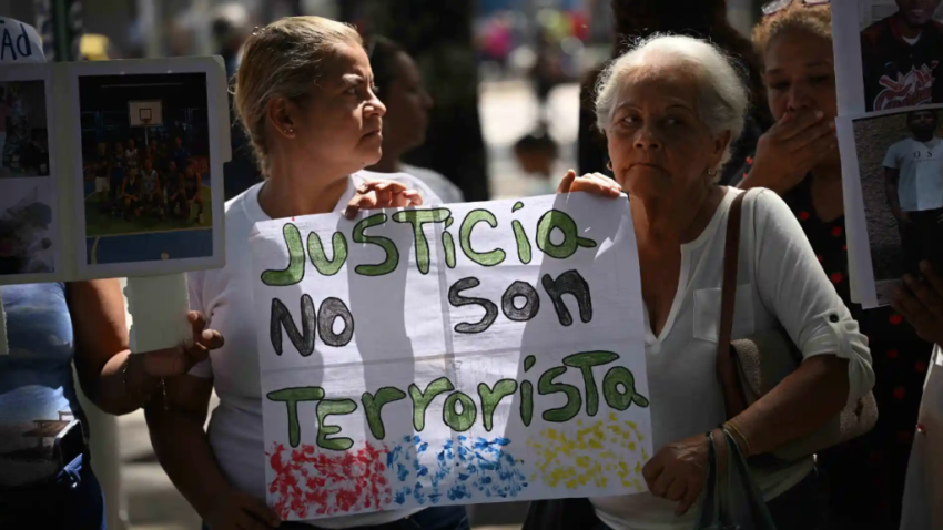 Two women holding a protest sign