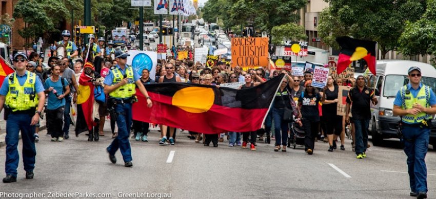 Aboriginal flag leads the march.