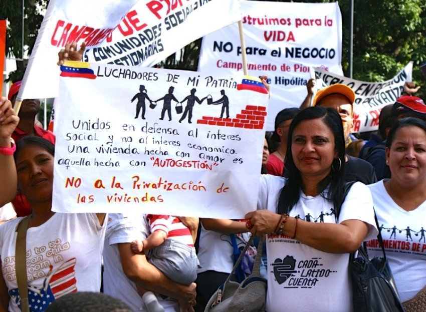 Venezuelans protest a new housing law that seeks privatise public housing, April 14 2016.