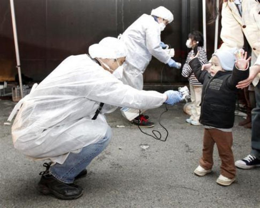 Children are scanned for radiation exposure outside Fukushima, March 12.