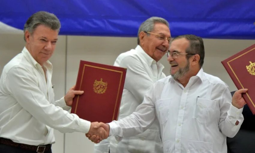 Colombian President Juan Manuel Santos and FARC commander Timoleon Jimenez at a signing ceremony in Havana, Cuba for a historic ceasefire in June.