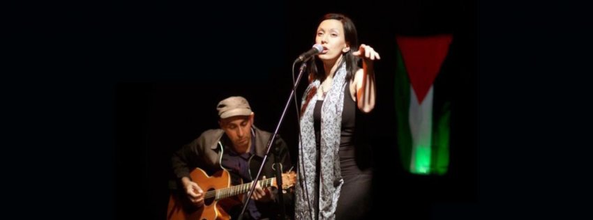 Palestinian performance poet Rafeef Ziadah on stage with Phil Monsour.