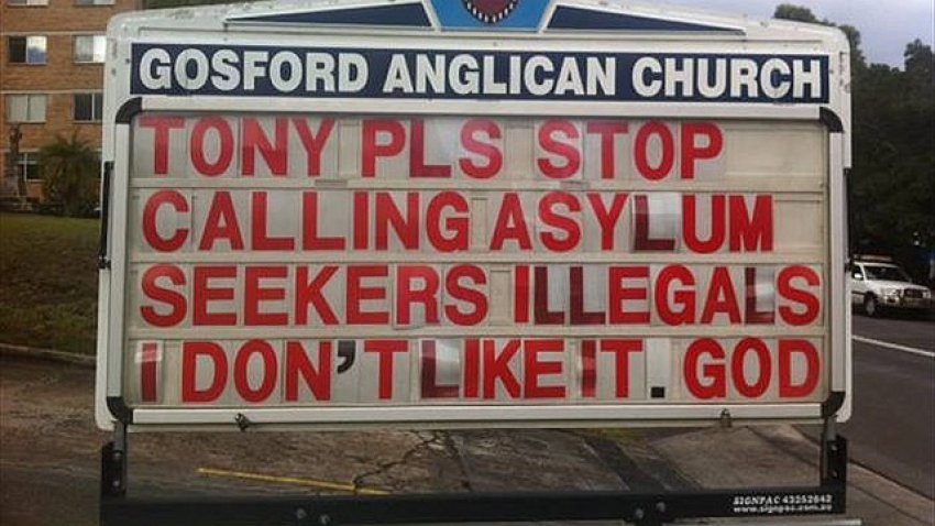 A pro-refugee billboard outside the church.