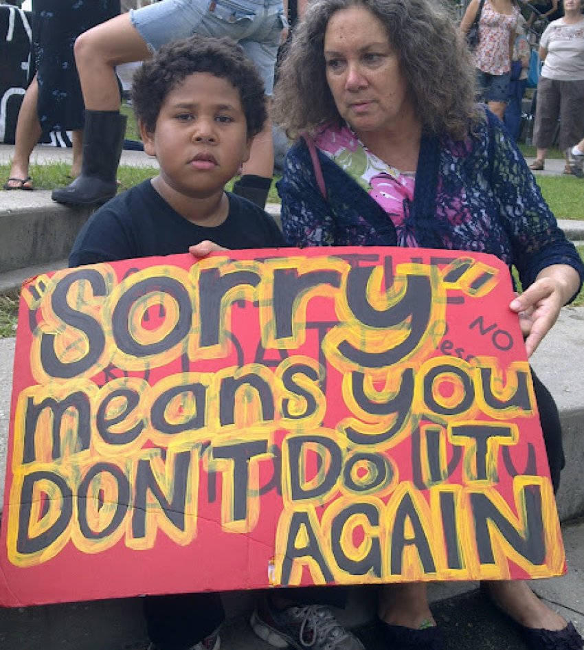 Placards that reads "Sorry" means you don't do it again