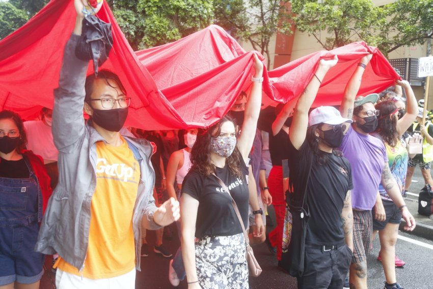 Carrying the huge Aboriginal flag