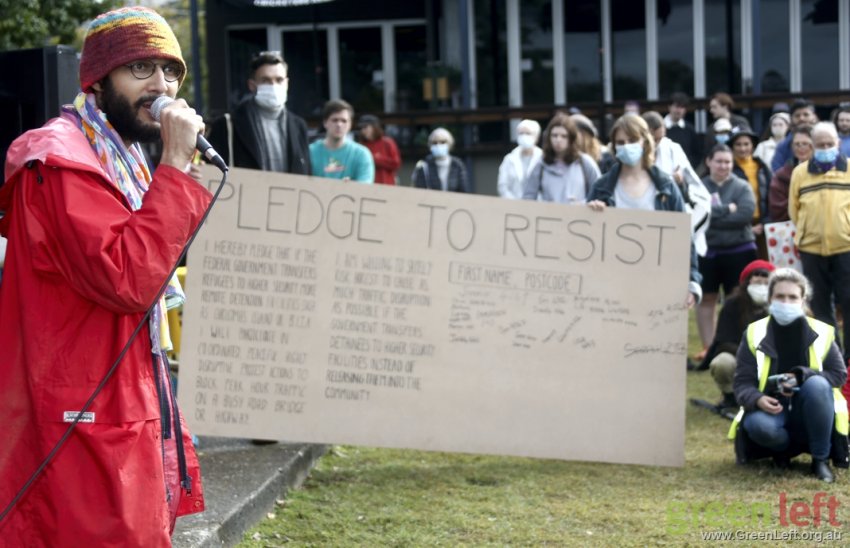 Greens coucillor Jonathan Sri encourages people to sign the pledge to resist