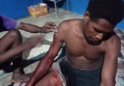 West Papuan shot by police having his wounds treated