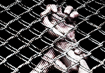 prisoner's hands behind wire