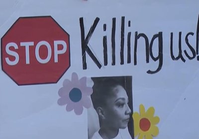 Sign with Sonya Massey's face reads "Stop killing us"