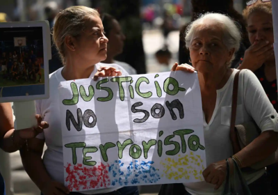 Two women holding a protest sign