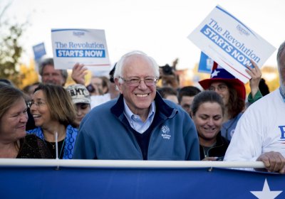 Bernie Sanders leads a group of supporters across a bridge in Des Moines.