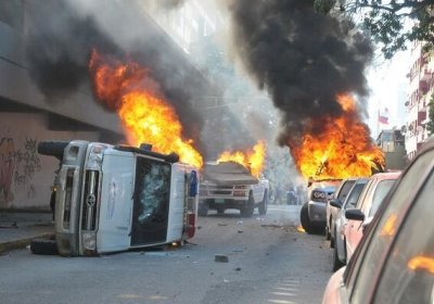 Cars burned by violent opposition protests, Caracas, February 12.