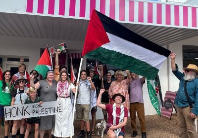 Activists pause at a sweet shop whose owner is a Palestine supporter.