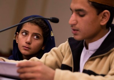 Nine-year-old Nabila Rehman (left) watches as her brother Zubair reads a statement.