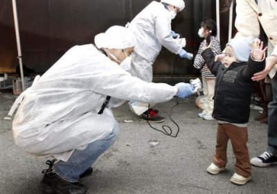 Children are scanned for radiation exposure outside Fukushima, March 12.