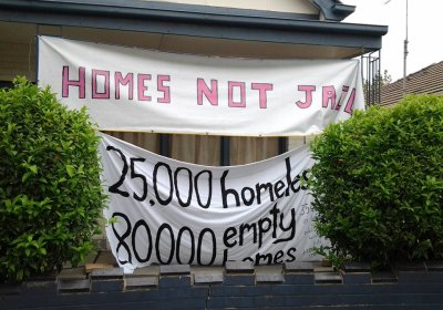 Homes not jail banner.