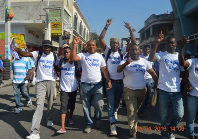 Slogan on T-shirts reads, "We will not obey".