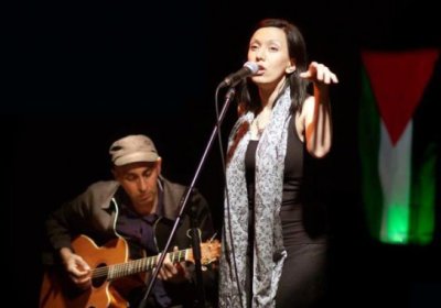 Palestinian performance poet Rafeef Ziadah on stage with Phil Monsour.