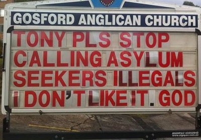 A pro-refugee billboard outside the church.