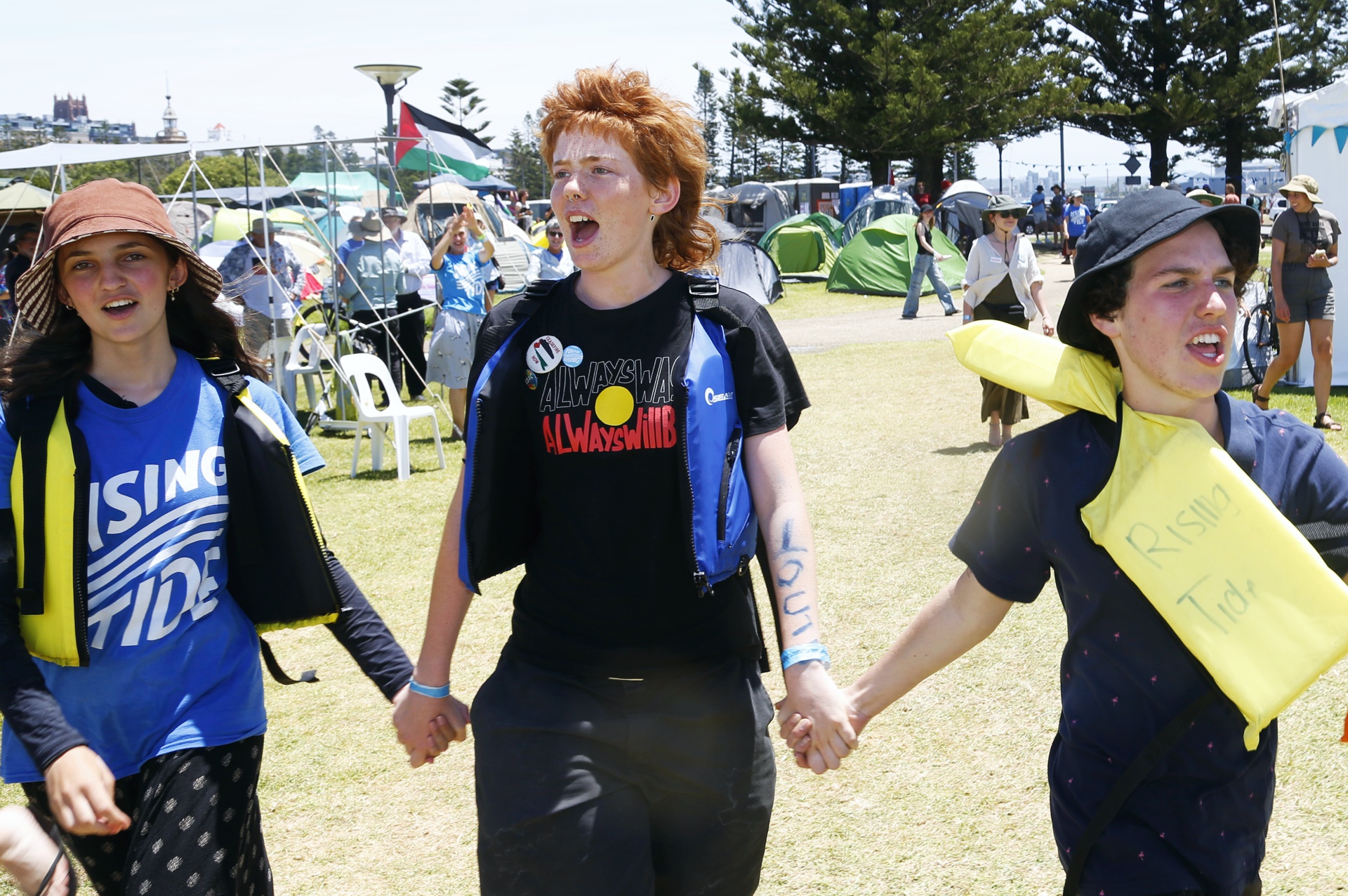 Young people return to camp after being arrested on the water